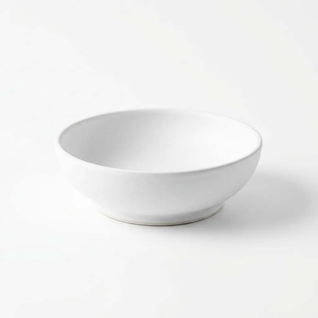 Studio photo of a ceramic cat bowl on white background